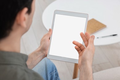 Sick man having online consultation with doctor via tablet at home, closeup