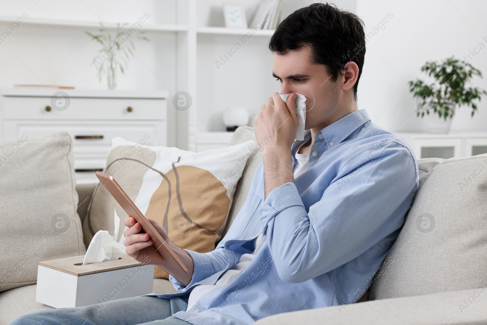 Photo of Sick man having online consultation with doctor via tablet at home