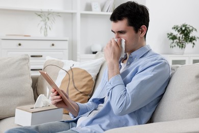 Sick man having online consultation with doctor via tablet at home