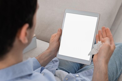 Photo of Sick man having online consultation with doctor via tablet at home