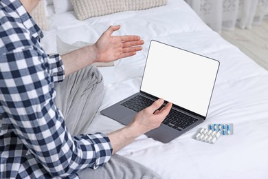 Photo of Sick man having online consultation with doctor via laptop at home, closeup