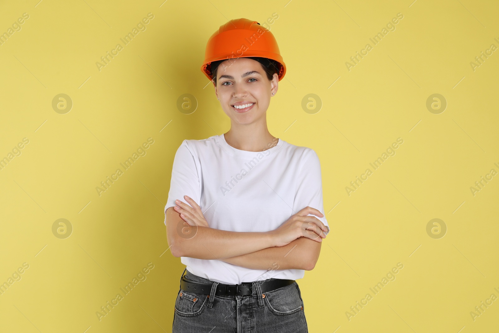 Photo of Engineer in hard hat on yellow background