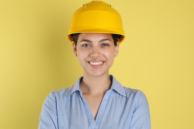 Engineer in hard hat on yellow background