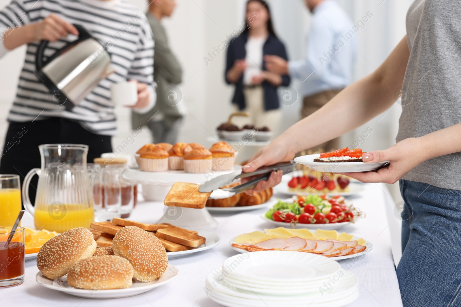 Photo of Coworkers having business lunch in restaurant, closeup