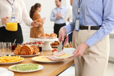 Coworkers having business lunch in restaurant, closeup