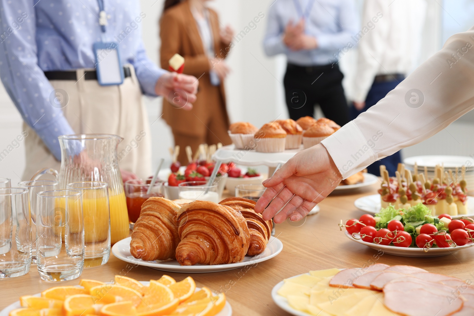 Photo of Coworkers having business lunch in restaurant, closeup