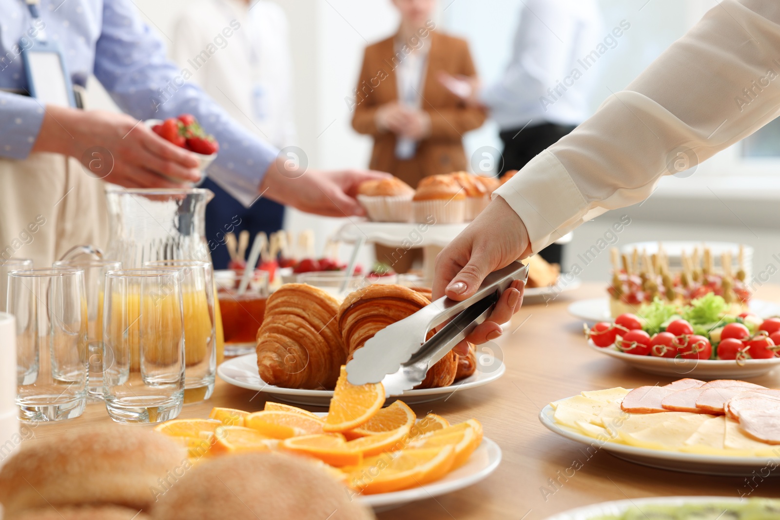 Photo of Coworkers having business lunch in restaurant, closeup