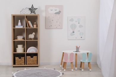 Child's room interior with modern furniture and beautiful pictures on wall