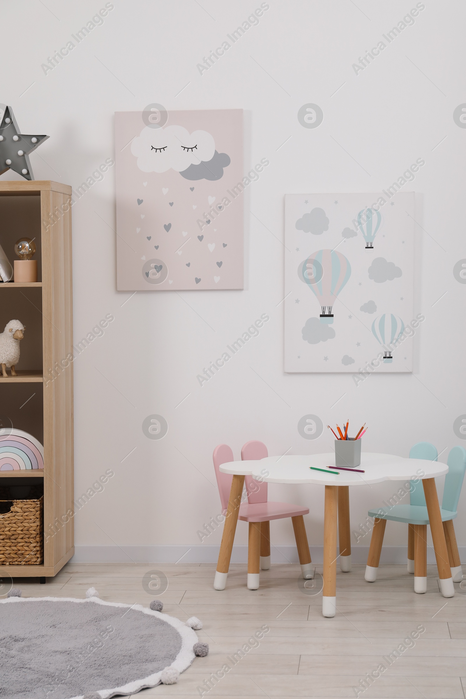 Photo of Child's room interior with modern furniture and beautiful pictures on wall