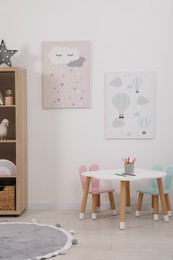 Child's room interior with modern furniture and beautiful pictures on wall