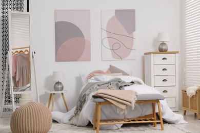 Teen's room interior with modern furniture and beautiful pictures on wall