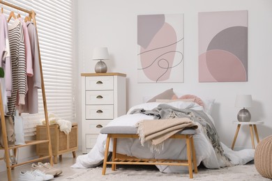 Teen's room interior with modern furniture and beautiful pictures on wall