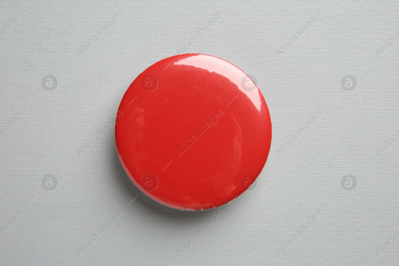 Photo of Blank red button badge on grey background, top view. Mockup for design