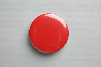 Blank red button badge on grey background, top view. Mockup for design