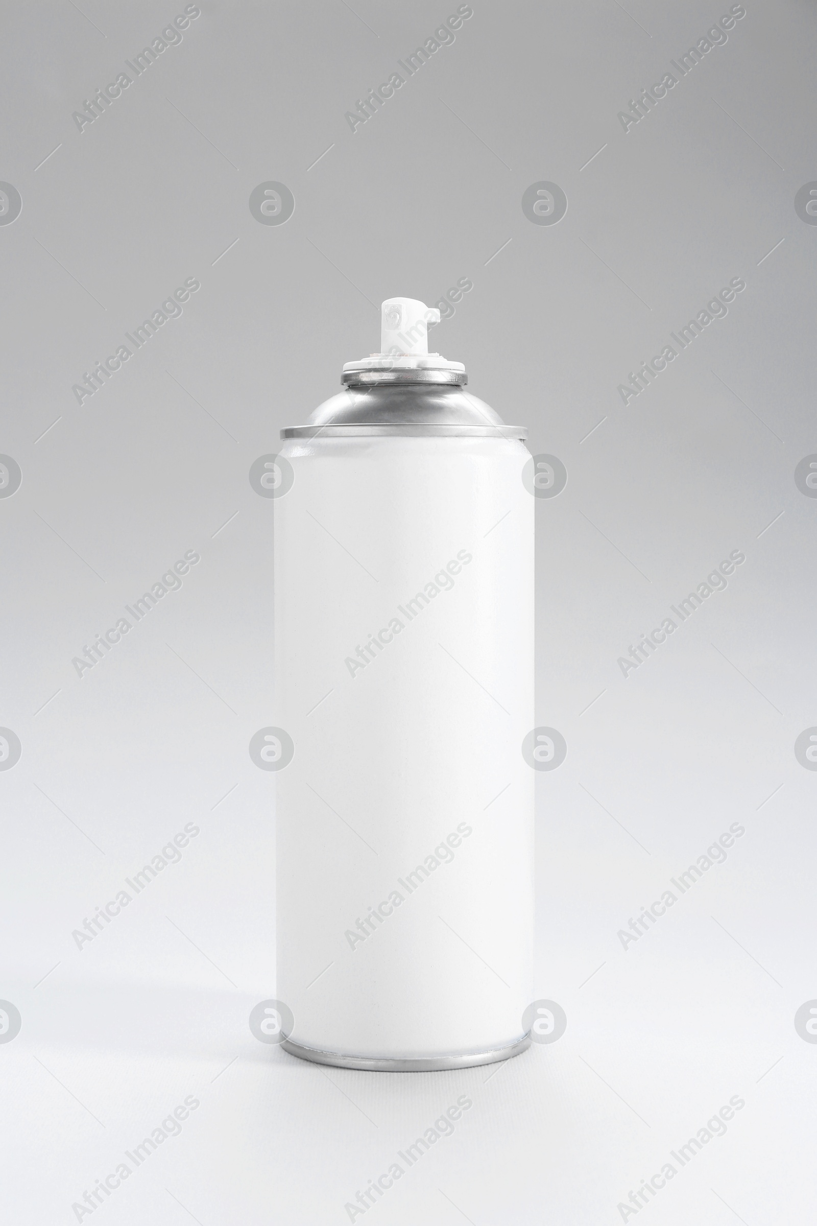 Photo of White spray paint can on gray background