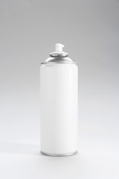 Photo of White spray paint can on gray background