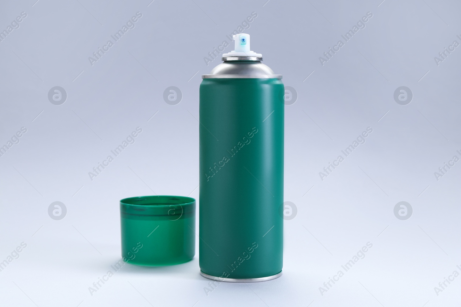 Photo of Green spray paint can on gray background