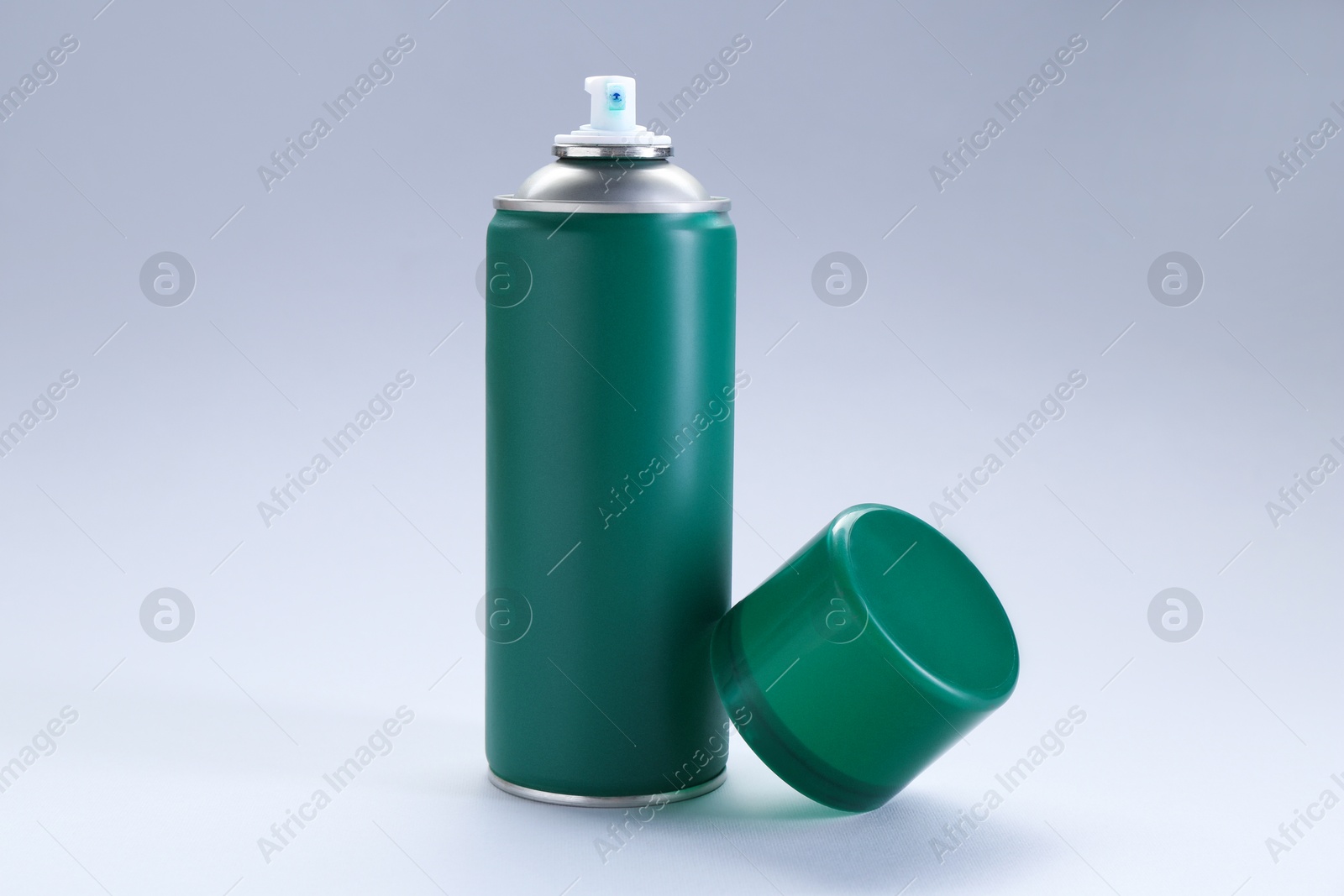 Photo of Green spray paint can on gray background