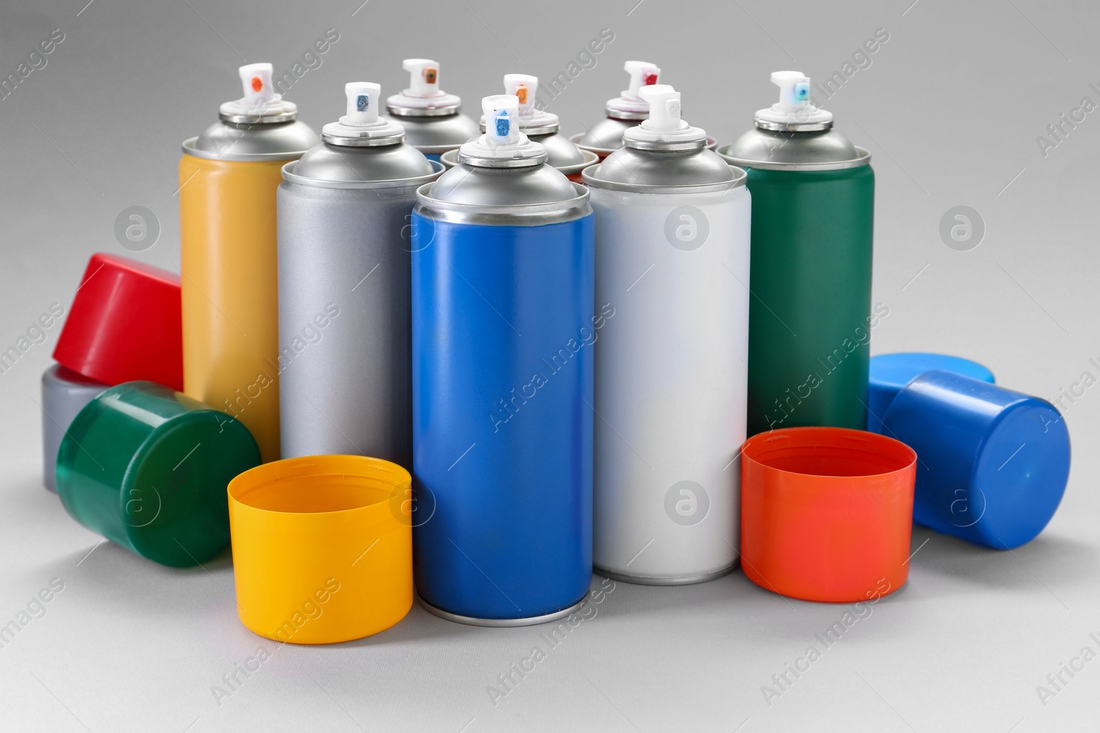 Photo of Many spray paint cans on gray background