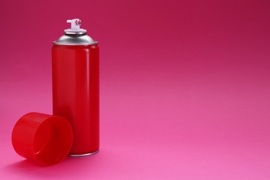 Photo of Red spray paint can on pink background, space for text