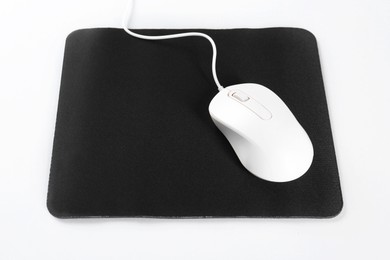 Photo of Wired mouse and mousepad on white background