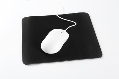 Wired mouse and mousepad on white background