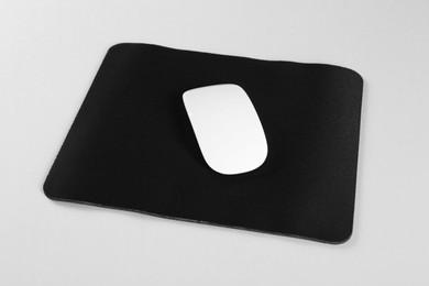 Photo of Wireless mouse and mousepad on white background