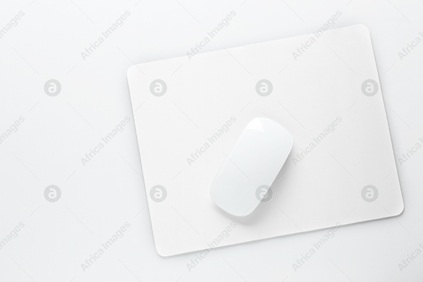 Photo of Wireless mouse and mousepad on white background, top view