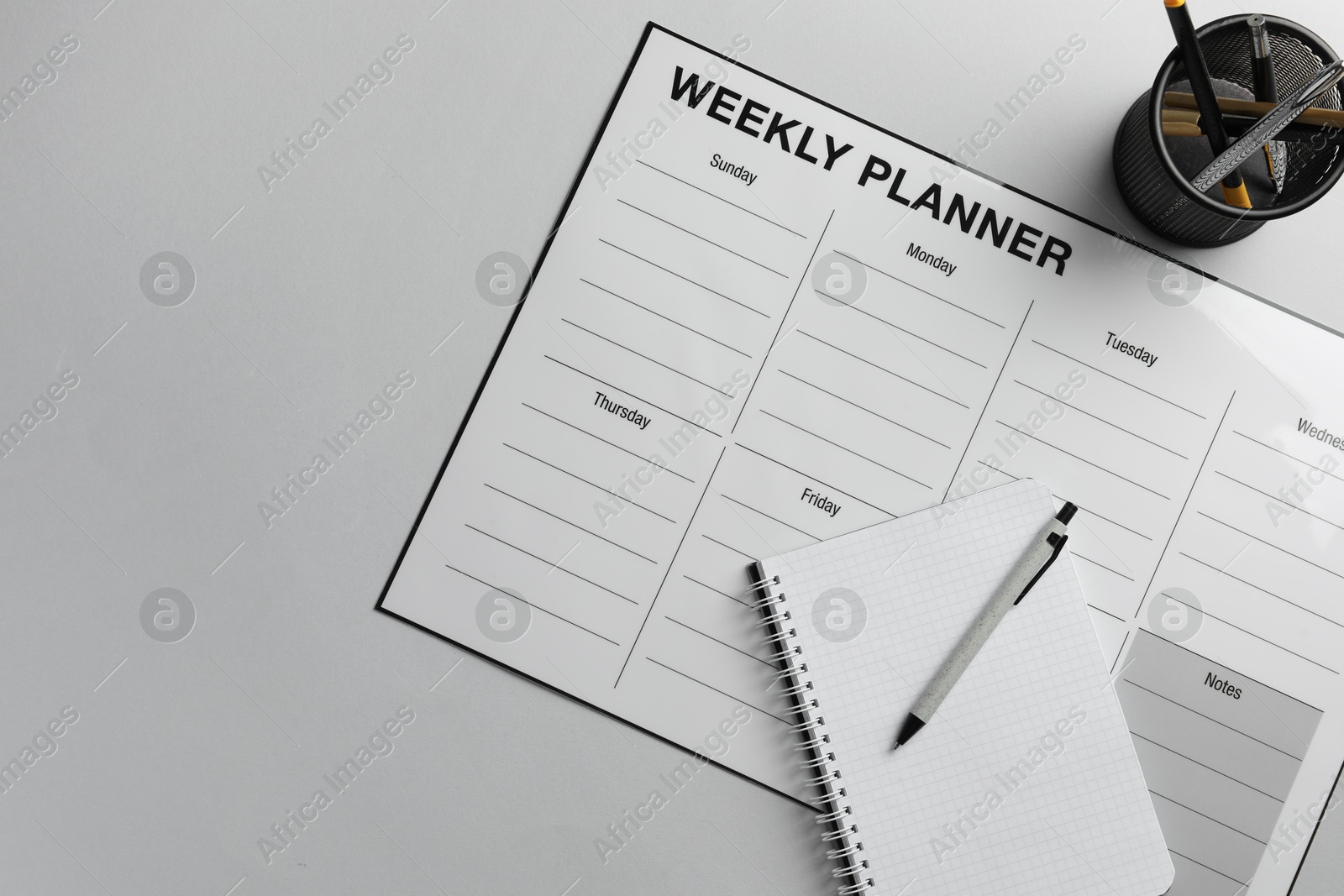 Photo of Timetable. Planner, notebook and pen on grey table, top view. Space for text