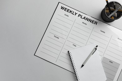 Timetable. Planner, notebook and pen on grey table, top view. Space for text