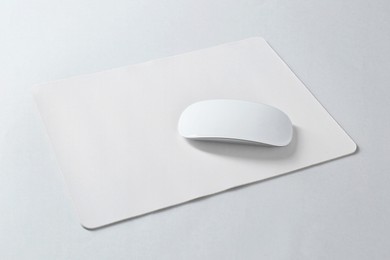 Wireless mouse and mousepad on white background