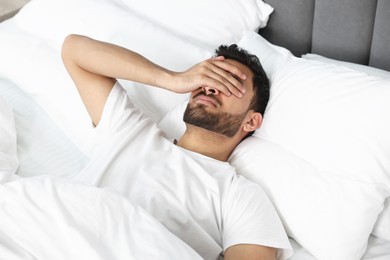 Photo of Morning of man suffering from headache in bed