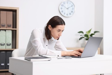 Photo of Woman with poor posture working in office