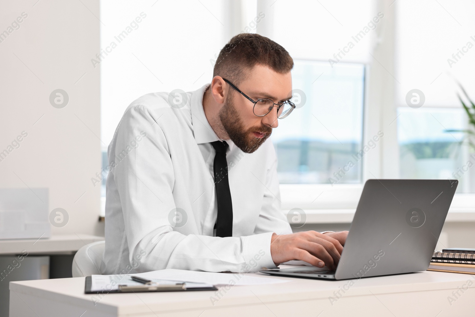 Photo of Man with poor posture working in office