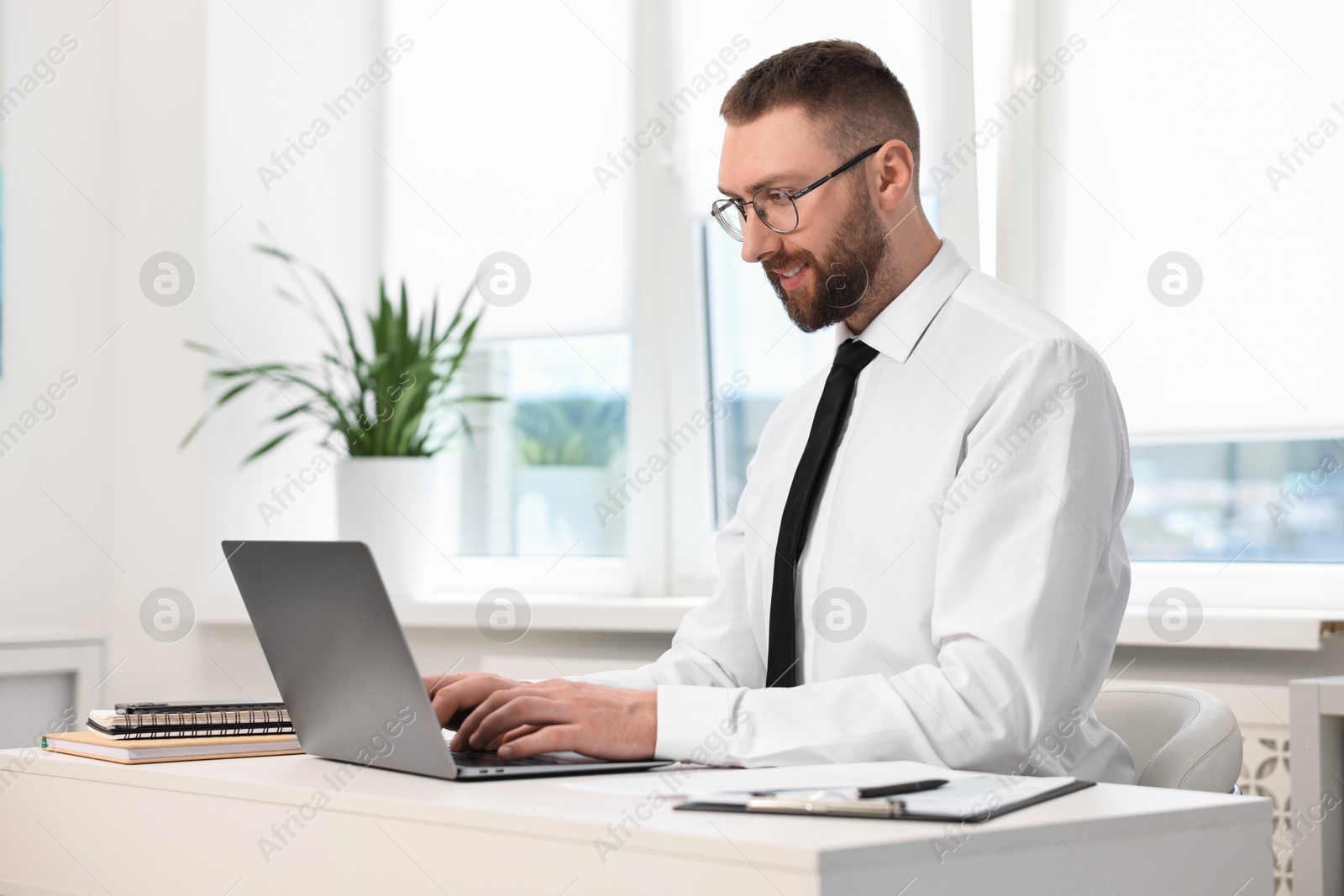 Photo of Man with good posture working in office