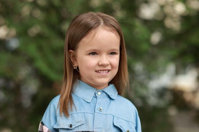 Photo of Portrait of happy little girl outdoors. Cute child