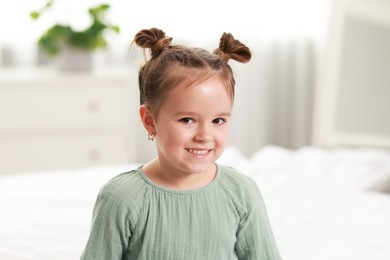 Portrait of happy little girl in bedroom