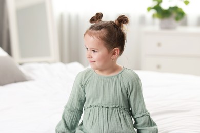 Photo of Portrait of beautiful little girl in bedroom. Cute child