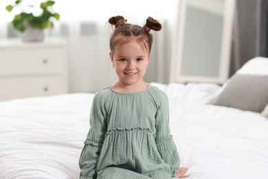 Photo of Portrait of happy little girl in bedroom