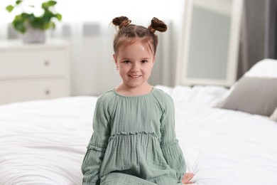 Portrait of happy little girl in bedroom