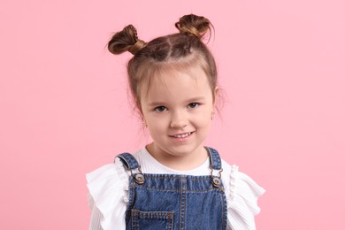 Photo of Portrait of cute little girl on pink background