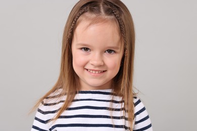 Photo of Portrait of happy little girl on grey background