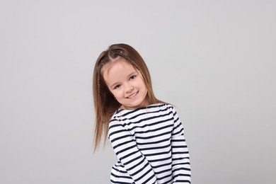 Photo of Portrait of happy little girl on grey background