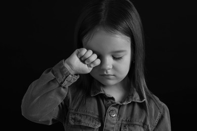 Photo of Portrait of sad girl on dark background, closeup. Black and white effect