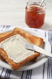 Photo of Delicious toasted bread slices with butter served on white table