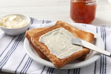 Delicious toasted bread slices with butter served on white table