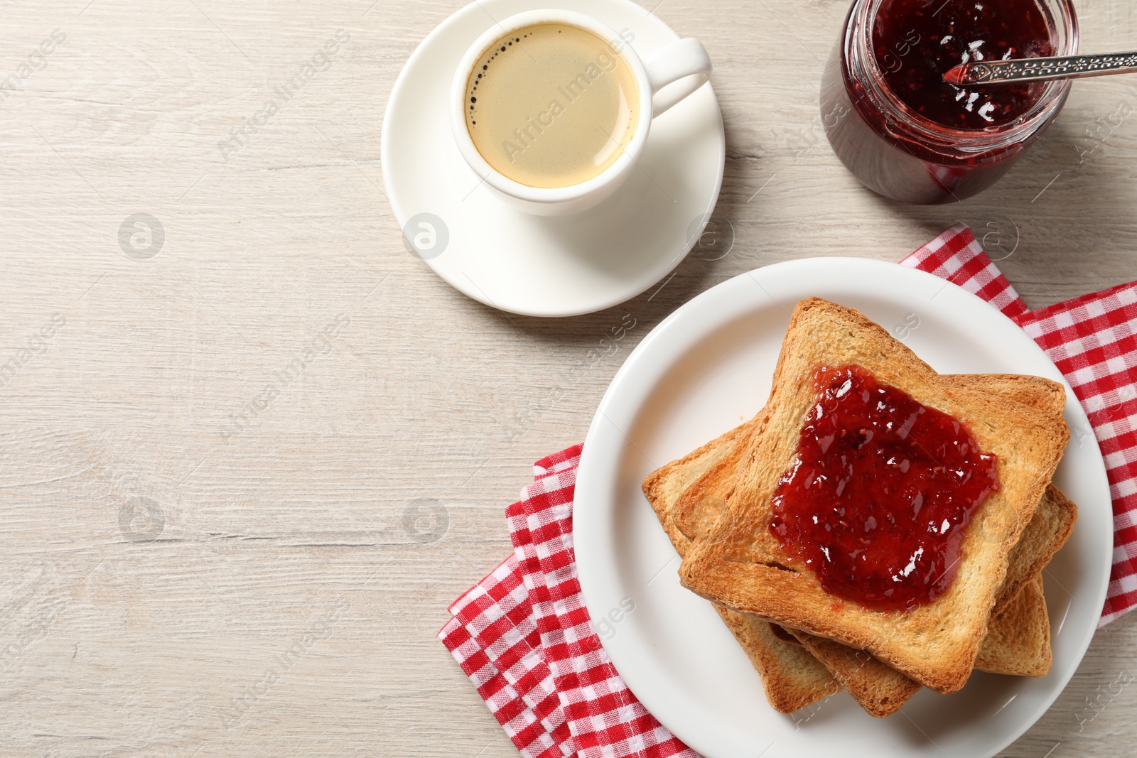 Photo of Delicious toasted bread slices served on wooden table, flat lay. Space for text