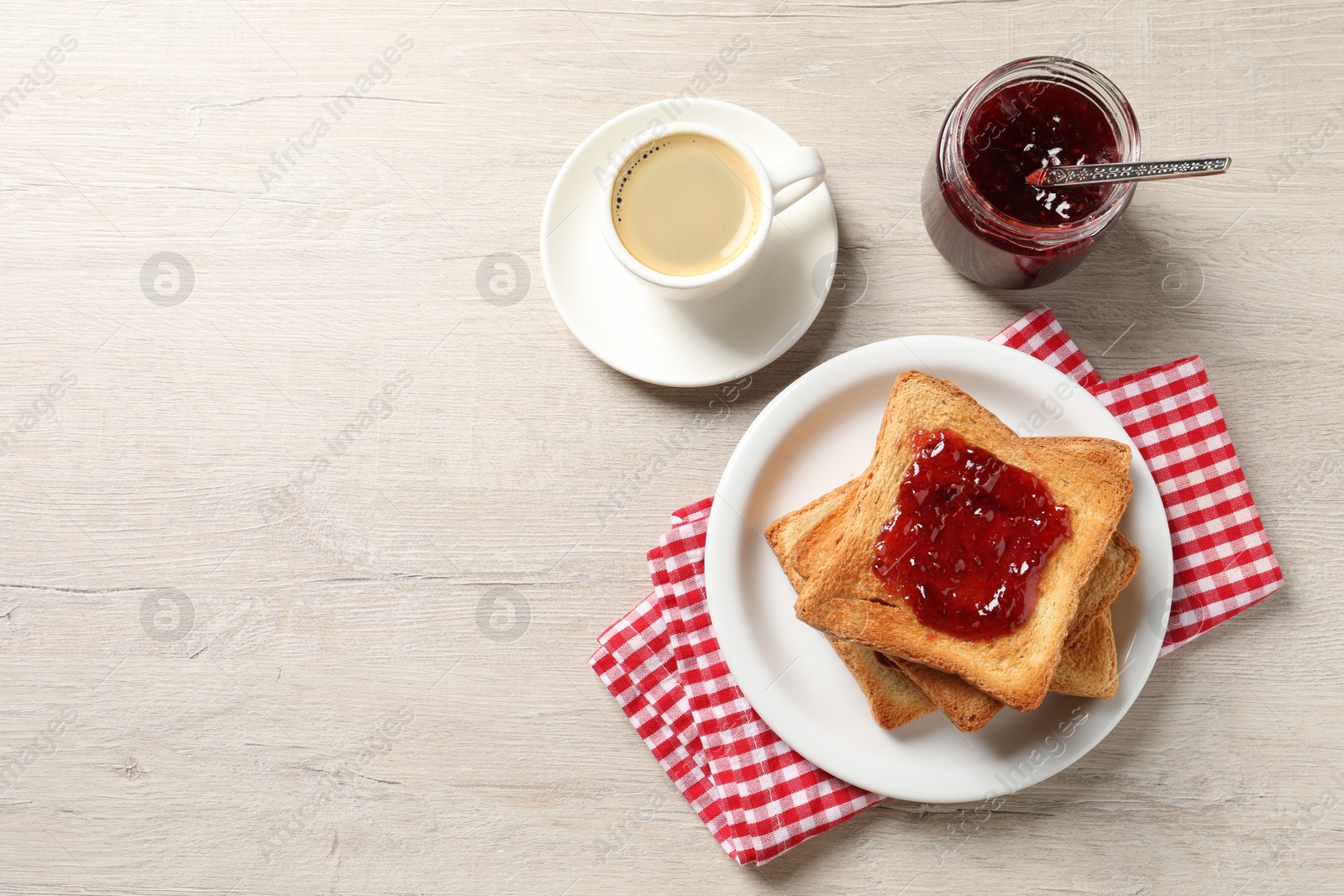 Photo of Delicious toasted bread slices served on wooden table, flat lay. Space for text