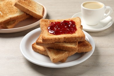 Photo of Delicious toasted bread slices with jam served on wooden table