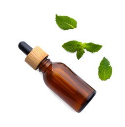 Photo of Bottle of essential oil and mint isolated on white, top view